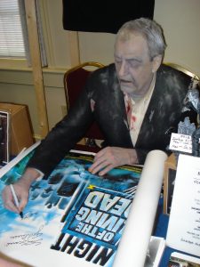 Bill Hinzman autographing a Night of the Living Dead British Quad movie poster